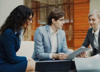 Professionals reviewing data on a tablet - UAE Competition Framework 2026