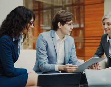 Professionals reviewing data on a tablet - UAE Competition Framework 2026