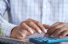 Small business owner using a calculator - UAE Small Business Relief 2029