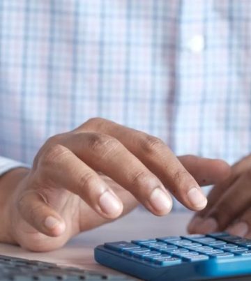Small business owner using a calculator - UAE Small Business Relief 2029